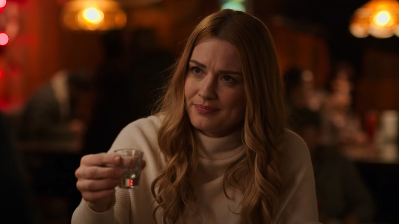 Mel Monroe lifts shot glass
