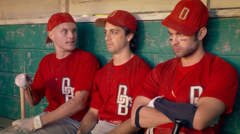 three players in the dugout