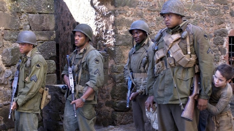 A group of soldiers and a little boy