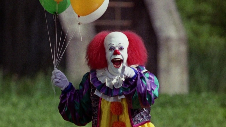 Tim Curry's Pennywise laughing and pointing in It