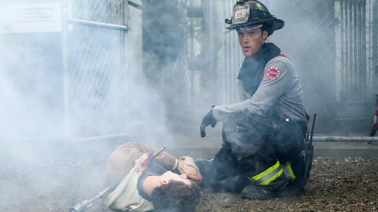 A firefighter sits over a victim