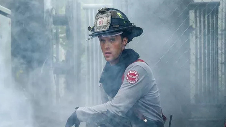 A firefighter sits over a victim
