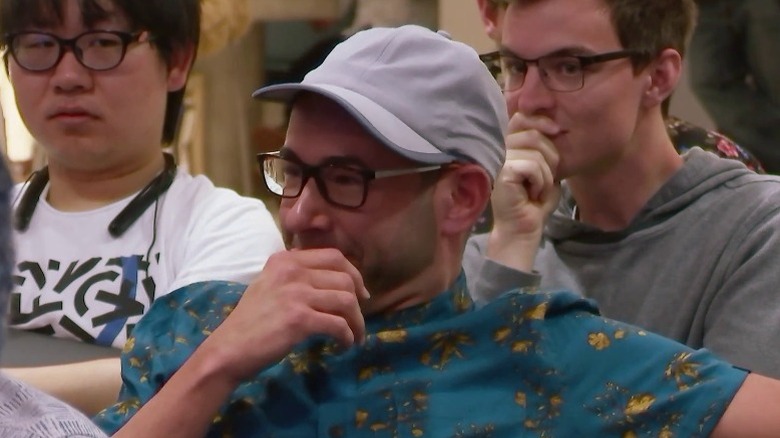 Murr covering face with hand