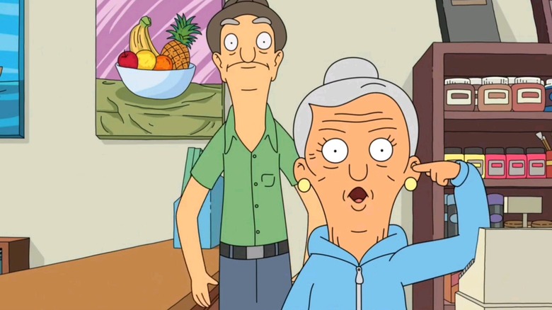 Edith with her finger in her ear and Harold standing