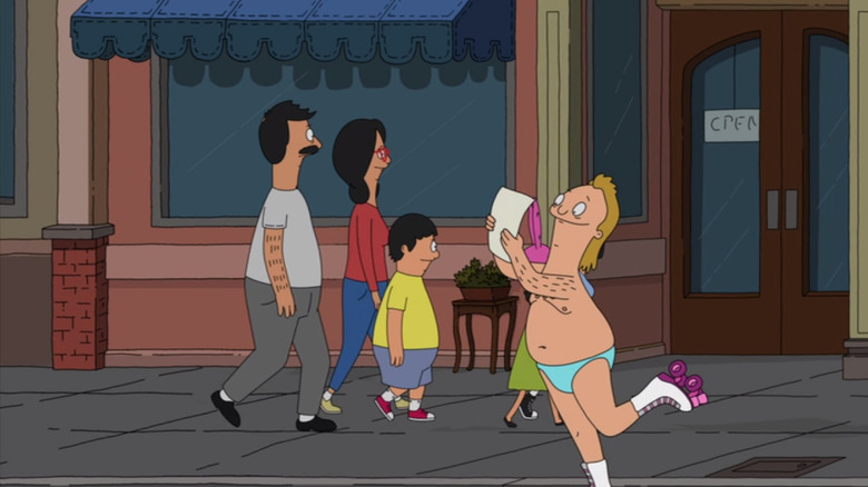 speedo guy reading in front of the belchers