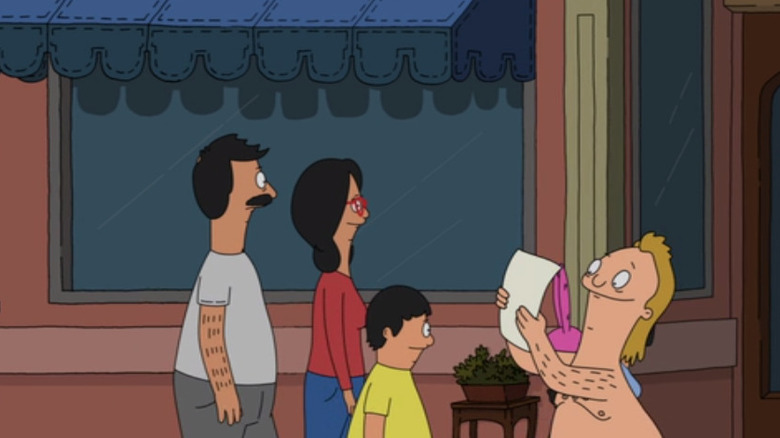 speedo guy reading in front of the belchers