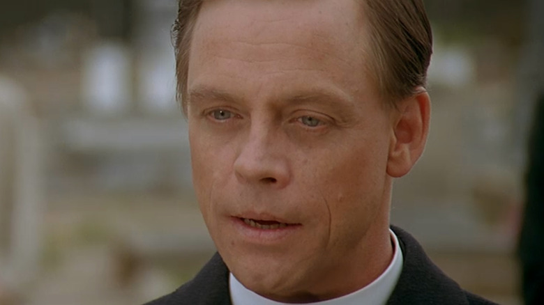 Village of the Damned's Reverend George speaking at funeral