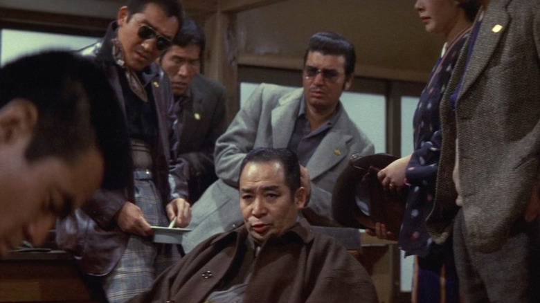 Group of gangsters, seated and talking