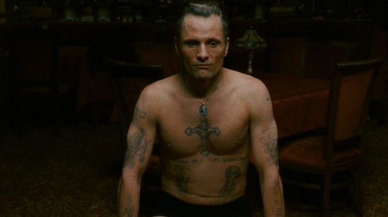 Shirtless Viggo Mortensen, seated
