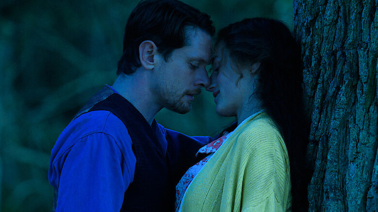 Oliver kisses Connie against a tree in Lady Chatterley's Lover (2022)