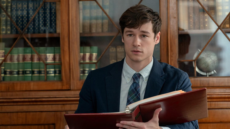 Brad looking confused with a big book in The Life List (2025)