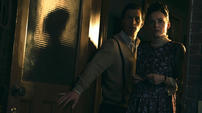 Ed and Lorraine Warren looking into a room in The Conjuring: Last Rites (2025)