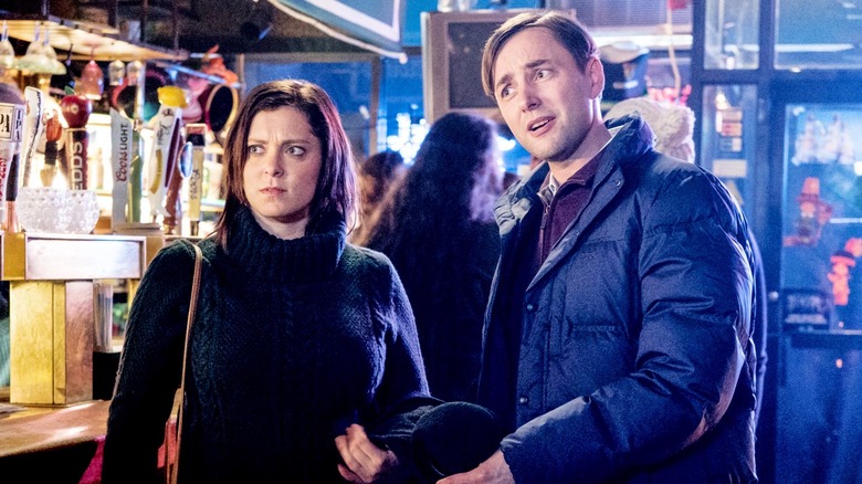 Rachel Bloom Adam Pally standing in bar