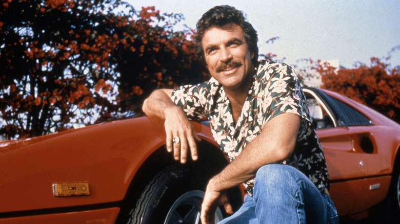 Magnum leans on a car in "Magnum P.I."