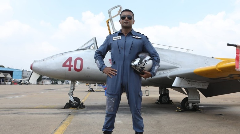 Nedumaaran Rajangam standing next to one of his jets in Soorarai Pottru (2020)