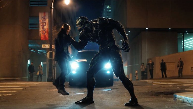 Venom holds a guy up