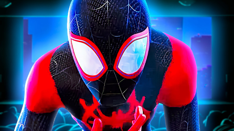 Miles Morales/Spider-Man looking down in front of city backdrop