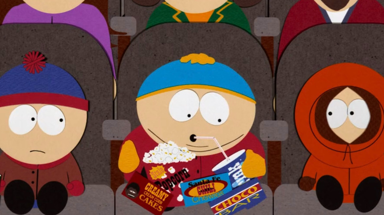 Cartman eating a bunch of snacks at a movie theater in South Park: Bigger, Longer and Uncut