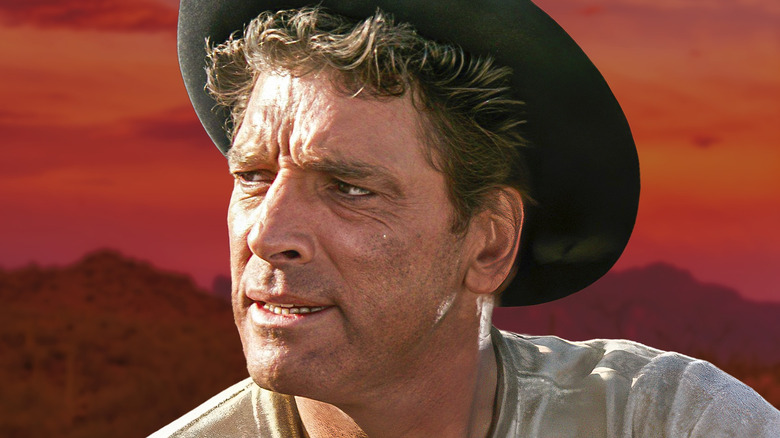 Burt Lancaster looking serious and wearing a cowboy hat