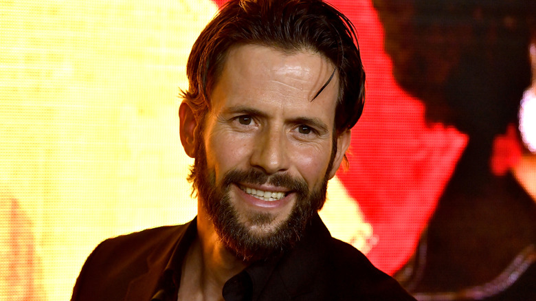 Christian Oliver smiles at the premiere of Amazon's "Hunters"