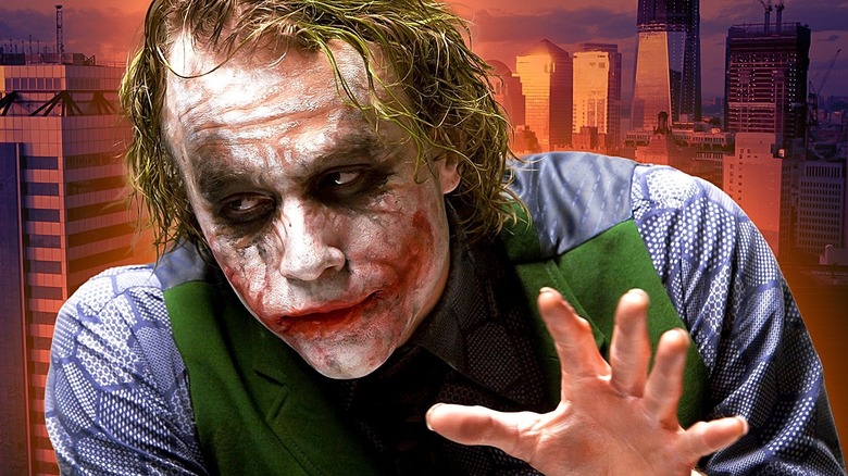 The Joker gesturing in The Dark Knight with Gotham behind