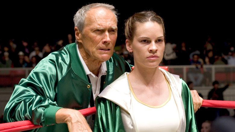 Frankie Dunn standing behind Maggie Fitzgerald in the ring