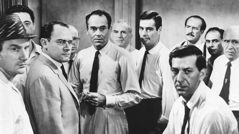 Eleven jurors listen to another juror in "12 Angry Men" (1957)