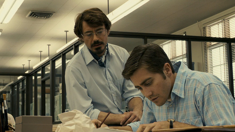 Paul and Robert working at a news desk in Zodiac