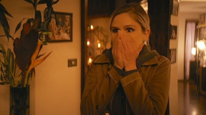 Annie holding her mouth in shock in Herogasm
