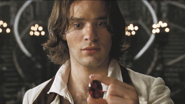 Tristan looking at the ruby in Stardust