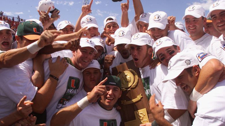 Players from the University of Miami holding up the championship trophy