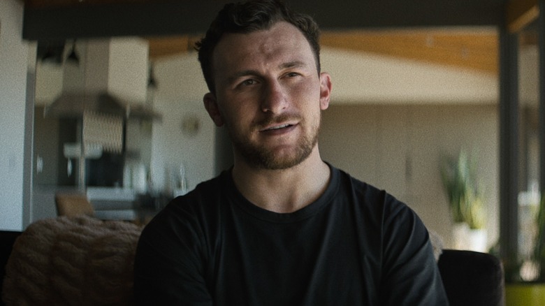 Johnny Manziel sitting in a house in a black t-shirt in Untold: Johnny Football (2023)