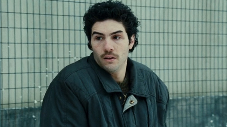 Mailk standing in a coat outside in A Prophet (2009)