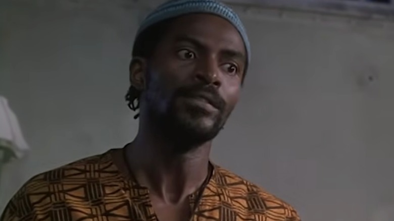 Ali looks serious in cap and tunic South Central (1992)