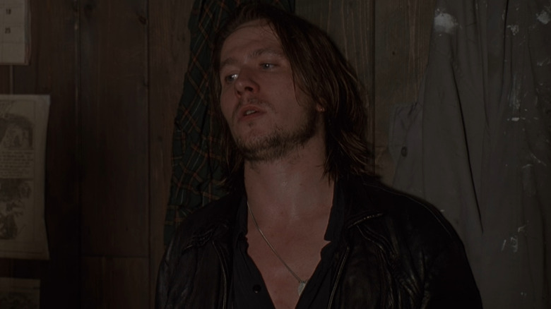 Jackie leaning against a wall looking nervous in State of Grace (1990)
