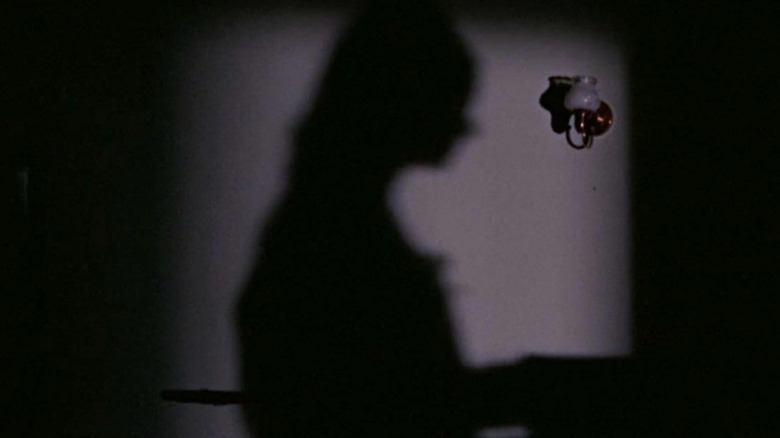 The shadow of a girl playing the piano in "Even the Wind Is Afraid"