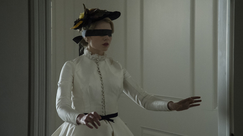 A blindfolded Lucy walks with her hands extended in front of her in "I Am the Pretty Thing That Lives in the House"