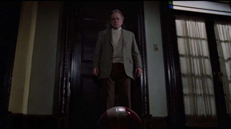 John staring at a red ball on the floor in "The Changeling"