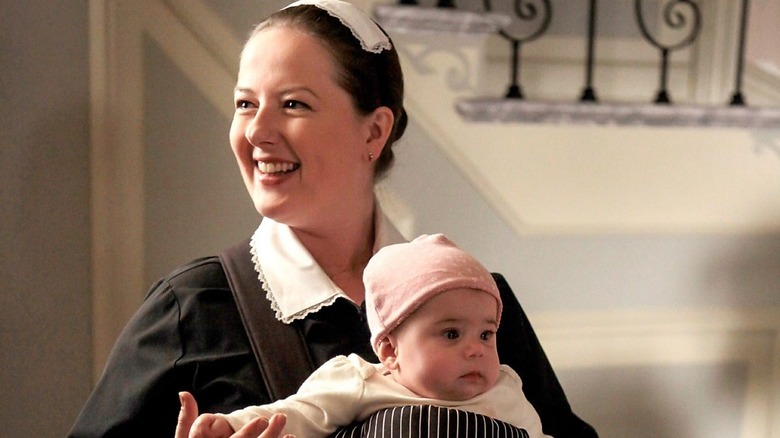 Dorota holding Anastasia in a snugli and smiling on Gossip Girl