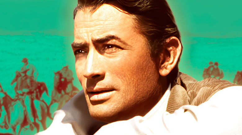 Gregory Peck looking off in the distance while cowboys prance behind him