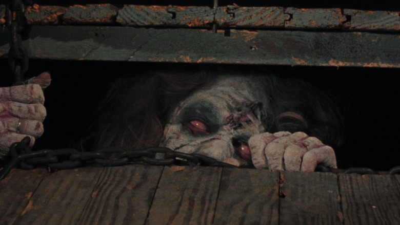 A Deadite crawls beneath the floorboards in "The Evil Dead"(1981)