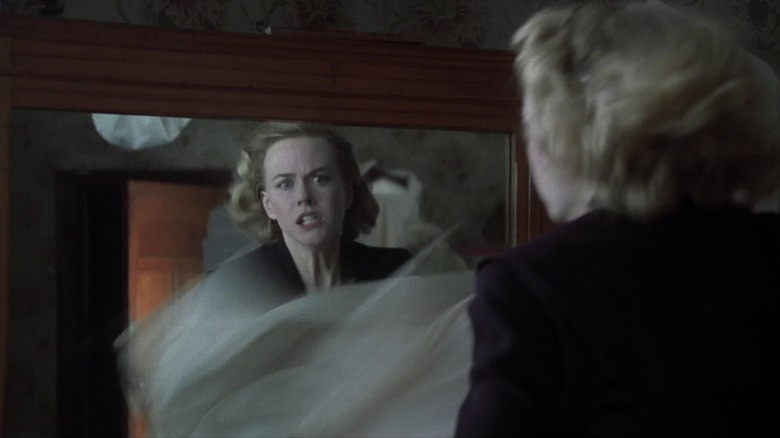 Grace sees something ghostly in the mirror in "The Others" (2001)