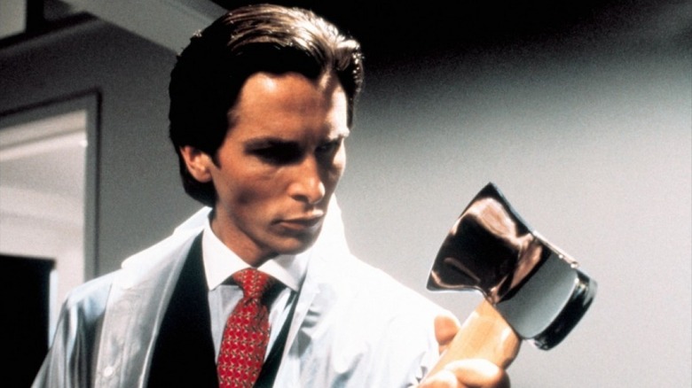 Patrick Bateman looking at his axe before committing a murder in American Psycho (2000)