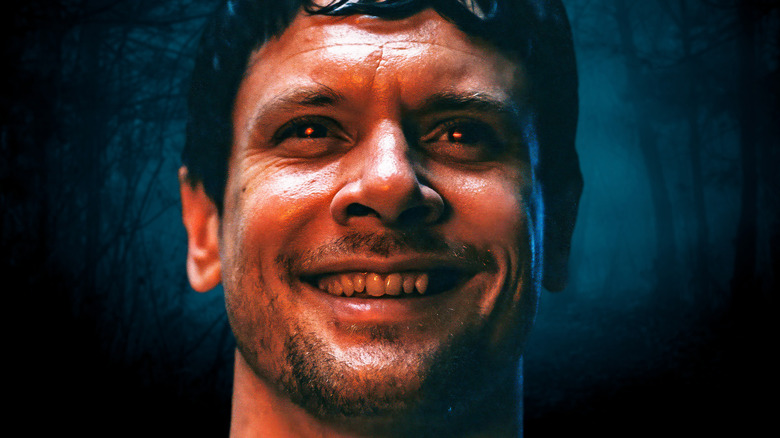 Remmick smiling and staring forward with red eyes in 