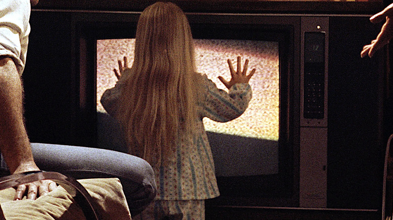 Carol Anne sees a ghost in the TV in Poltergeist (1982)
