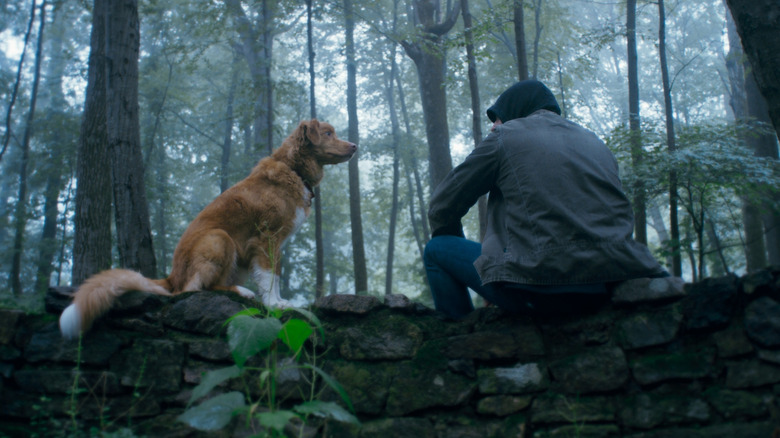 Indy and his owner sitting next to each other outside in Good Boy