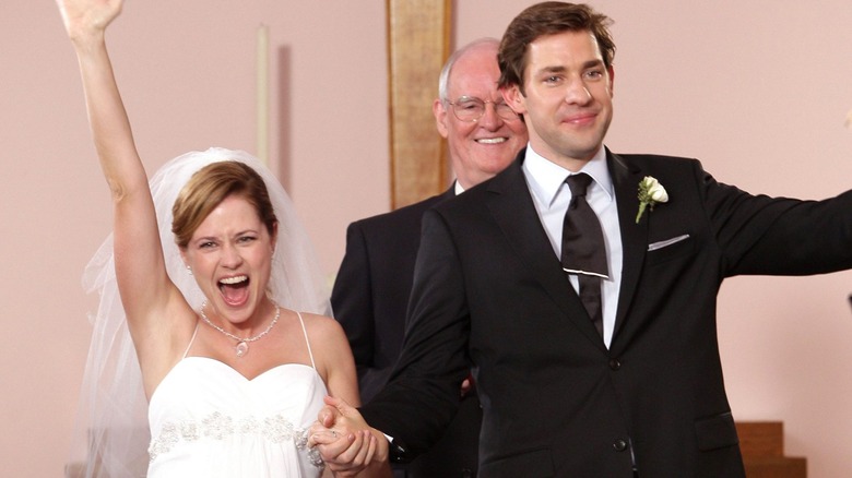 Pam and Jim cheering after their wedding on The Office