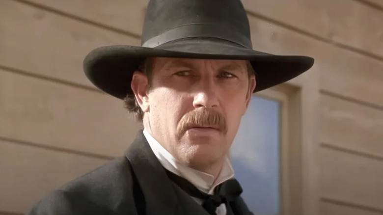 Wyatt Earp looking surprised in a black hat in Wyatt Earp