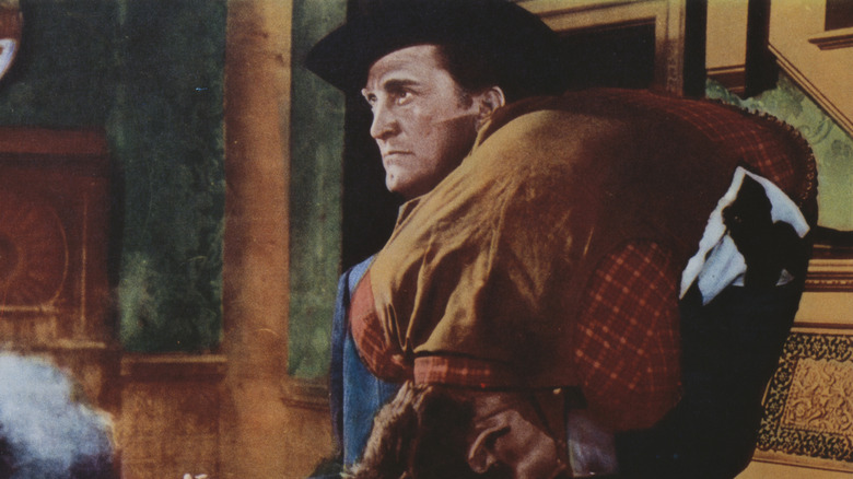 Morgan carrying a man in Last Train from Gun Hill