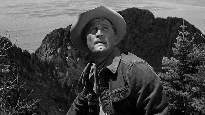 Jack Burns looking up concerned while wearing a cowboy hat in Lonely Are the Brave